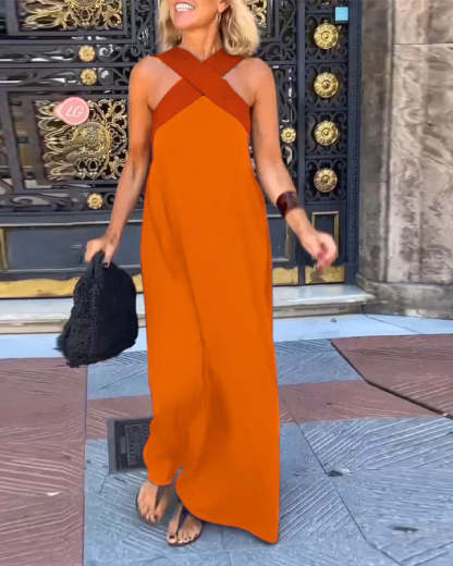 Bright orange maxi dress with rust crossover straps and asymmetrical hem