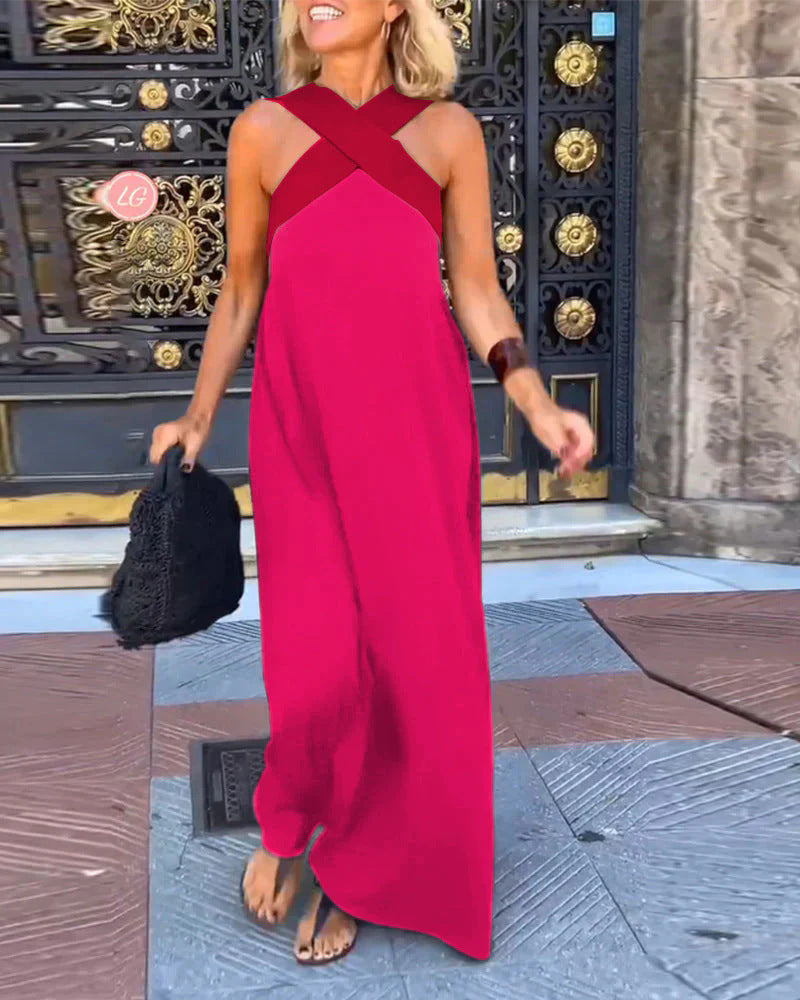 pink maxi dress with deep red crossover straps and asymmetrical train