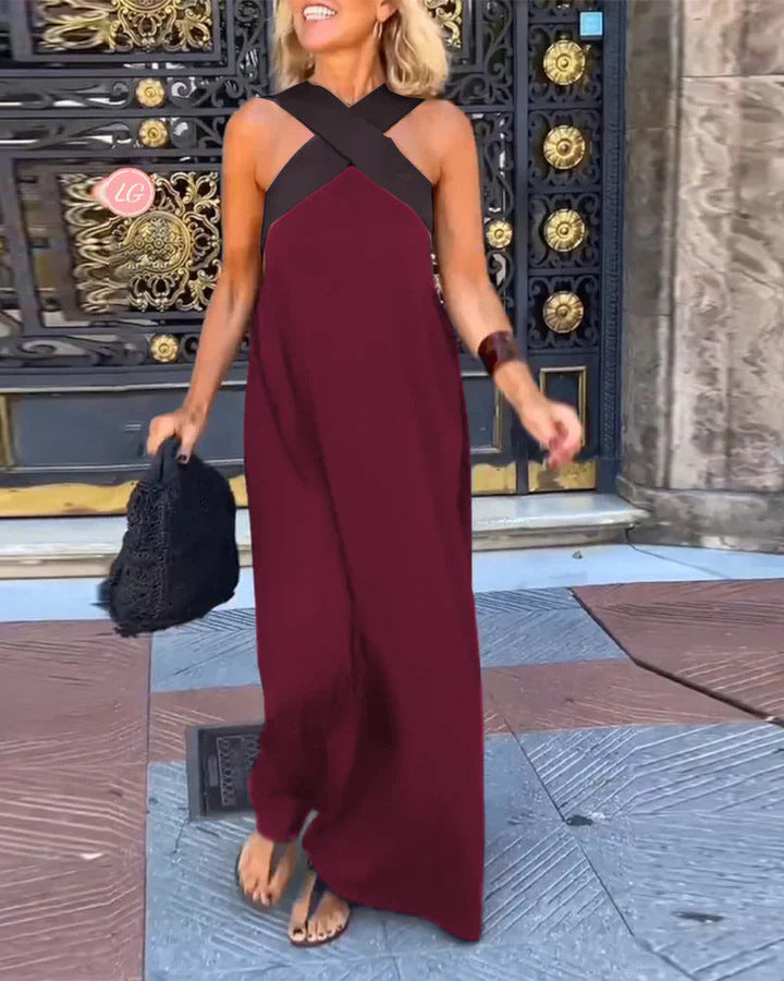 Burgundy maxi dress with black crossover straps and draped hem