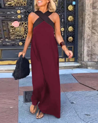 Burgundy maxi dress with black crossover straps and draped hem