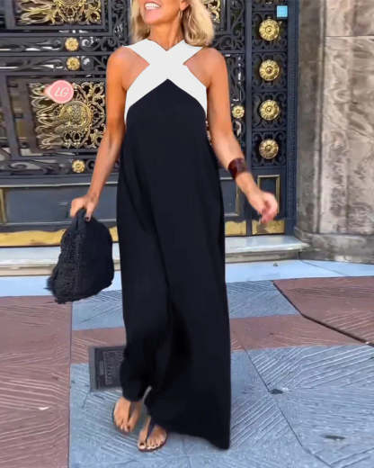 Black maxi dress with white crossover neckline and flowing skirt