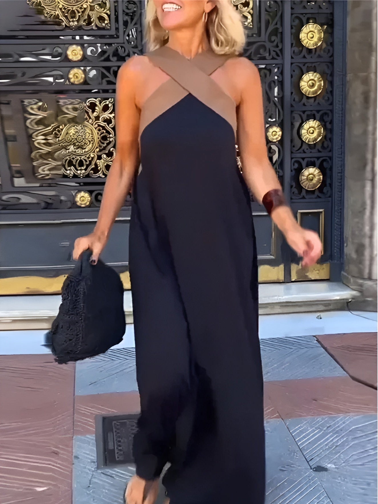 Black sleeveless maxi dress with crossover neckline and flowing silhouette