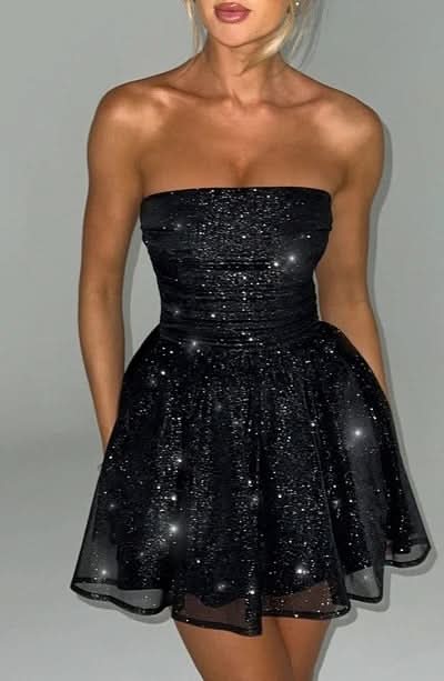 Front view of black sequin mini dress with fitted bodice and flared skirt