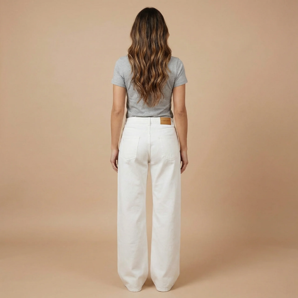 Back view of white straight-leg jeans with leather waistband patch and 5-pocket design
