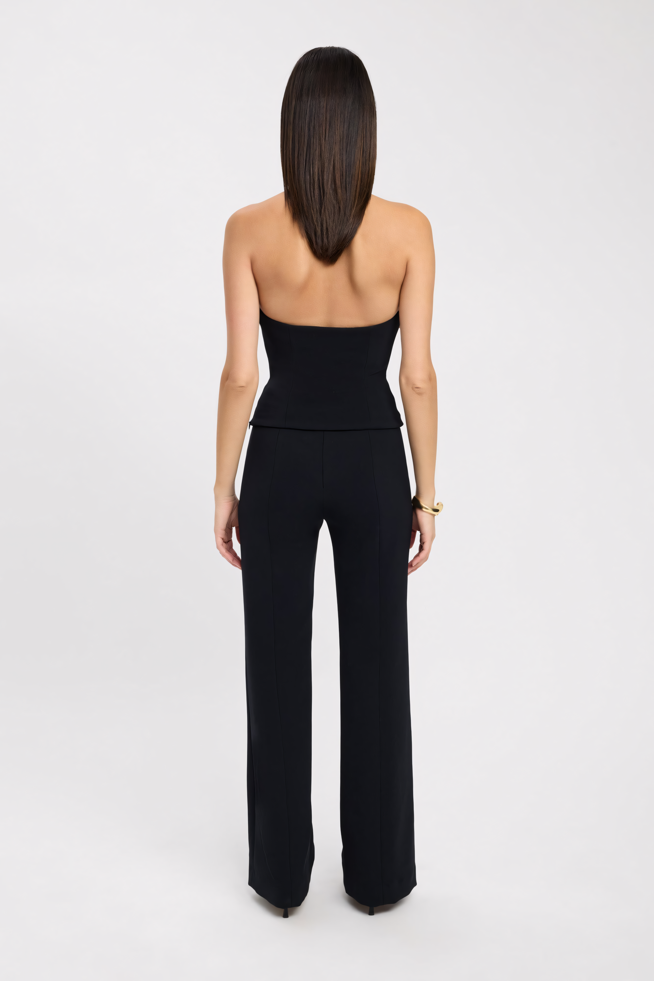 Back view of black halter bustier top showing center zip closure and open back design for women
