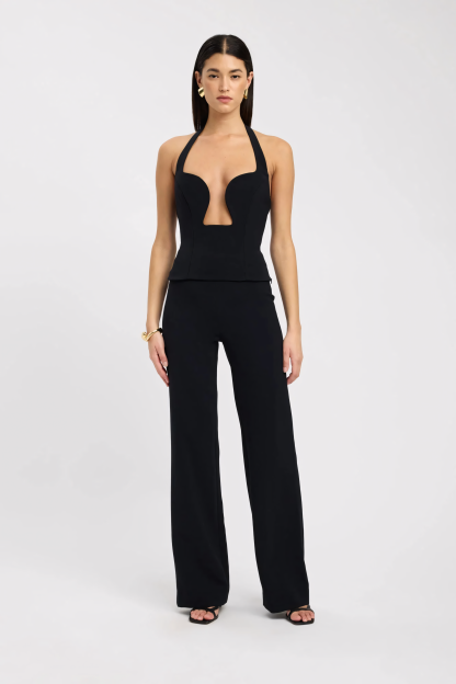 Black halter bustier top with plunge cutout and molded cups styled with high-waisted pants for women