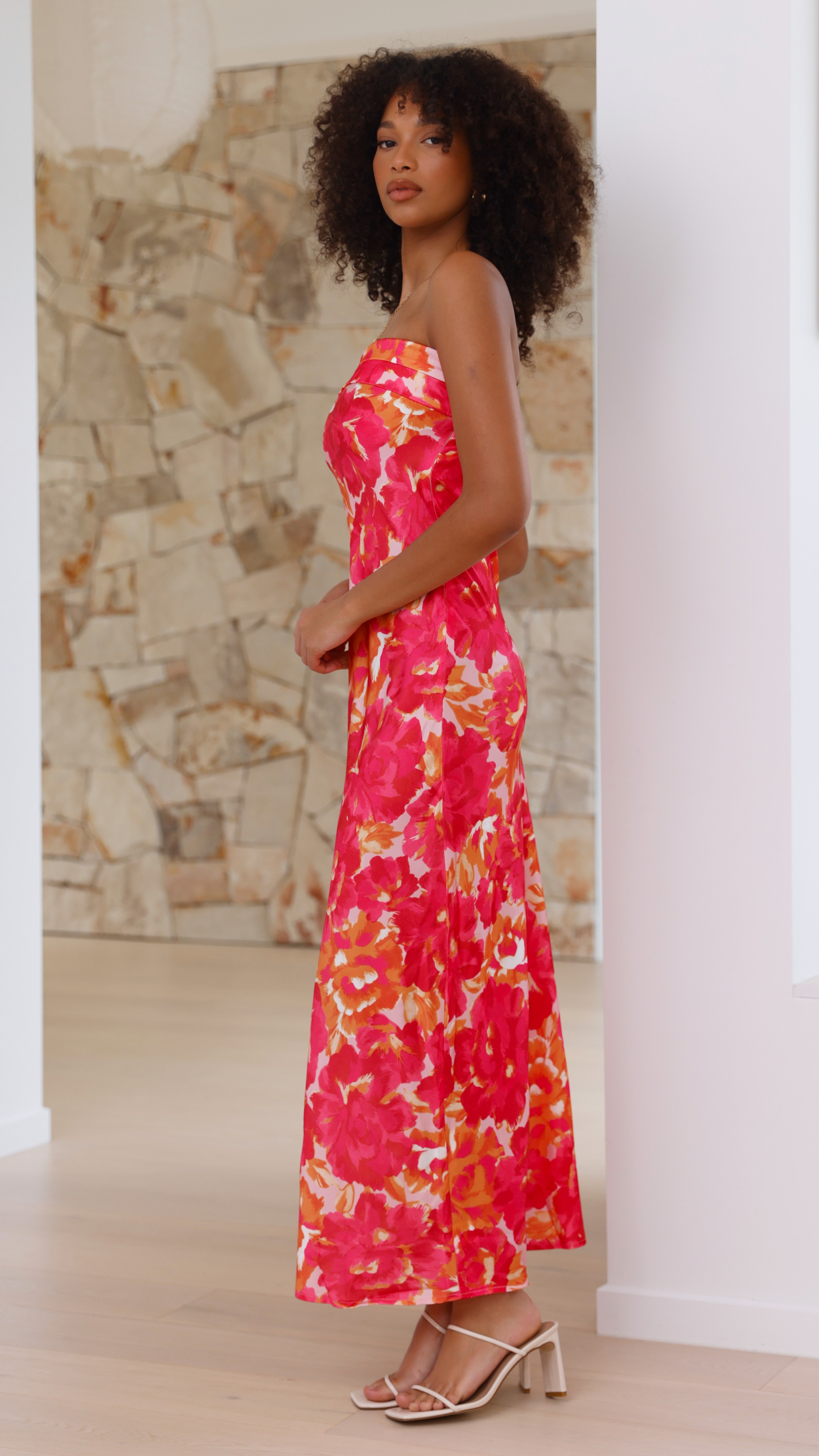 Side profile of pink floral midi dress with ruched strapless neckline
