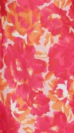 Close-up of pink floral fabric with orange and cream colored flowers