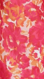 Close-up of pink floral fabric with orange and cream colored flowers
