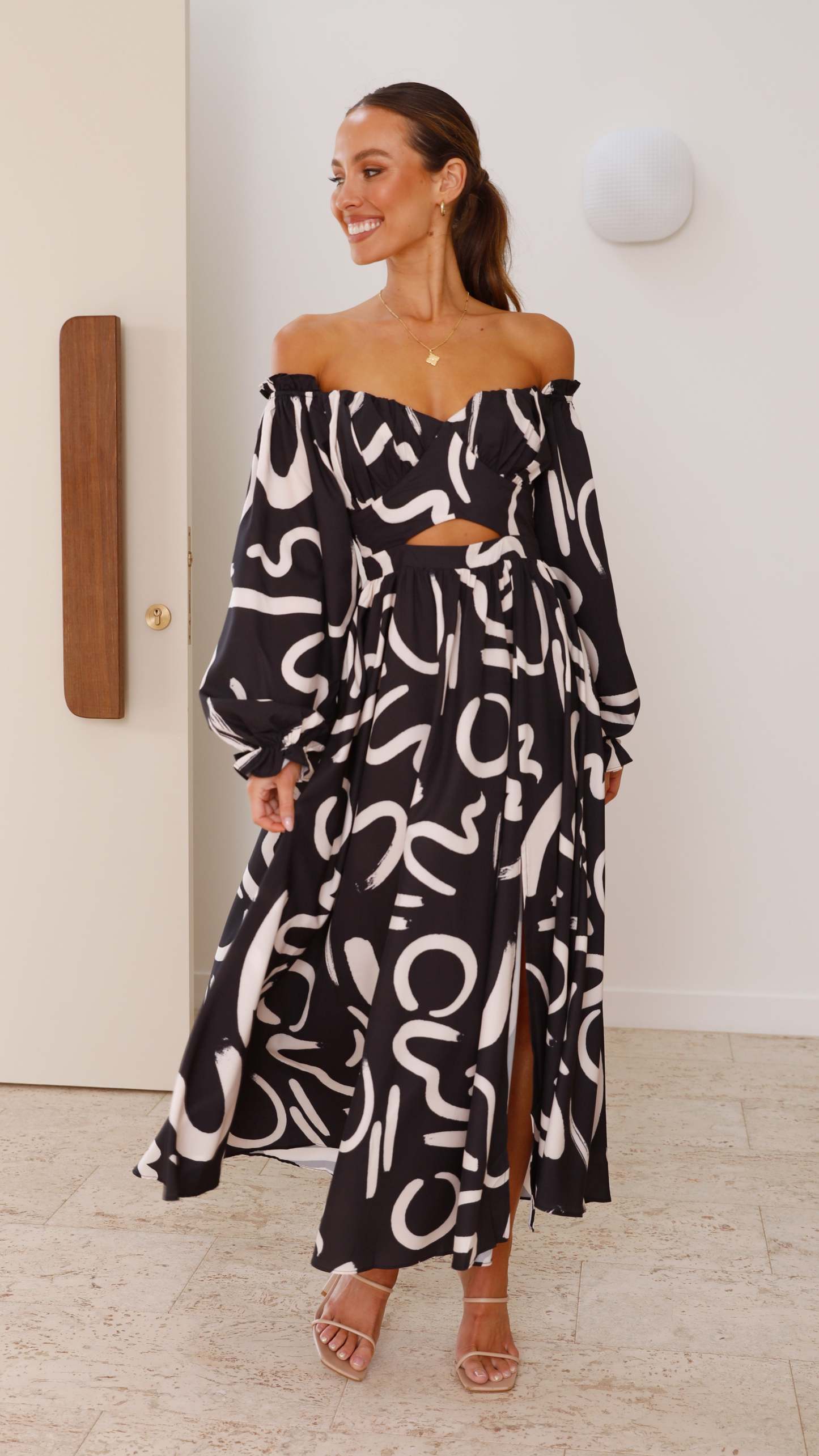 Black and white abstract pattern maxi dress with off-shoulder ruffle neckline