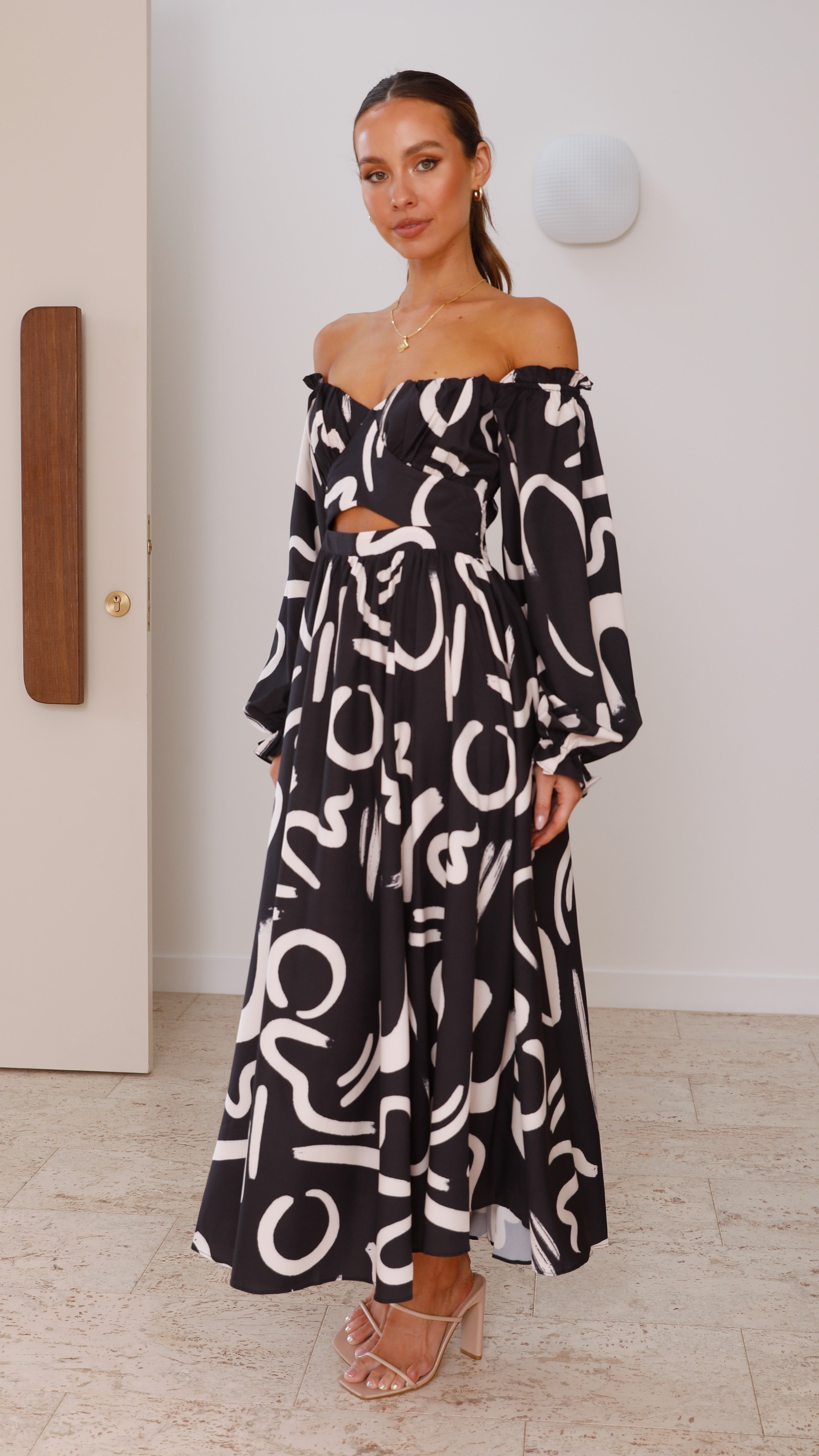 Abstract maxi dress featuring off-shoulder cut and waist cutout with puffed sleeves