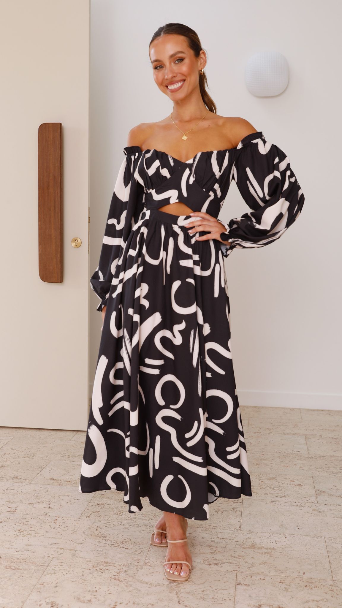 Black abstract maxi dress with cream swirl print, off-shoulder neckline and cutout detail