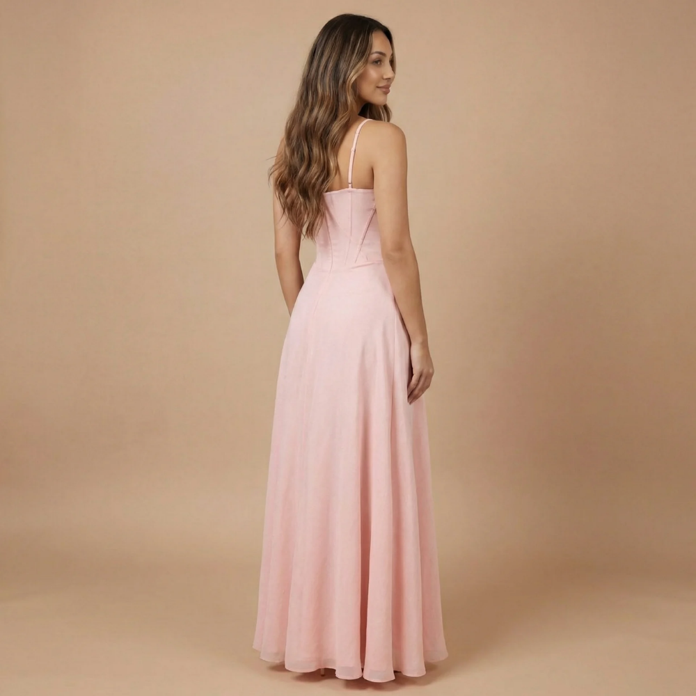 Blush pink corset maxi dress back view showing fitted bodice and draped skirt
