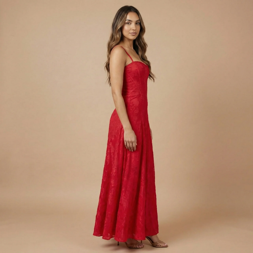 Red velvet corset maxi dress side profile showing fitted waist and flowing hem