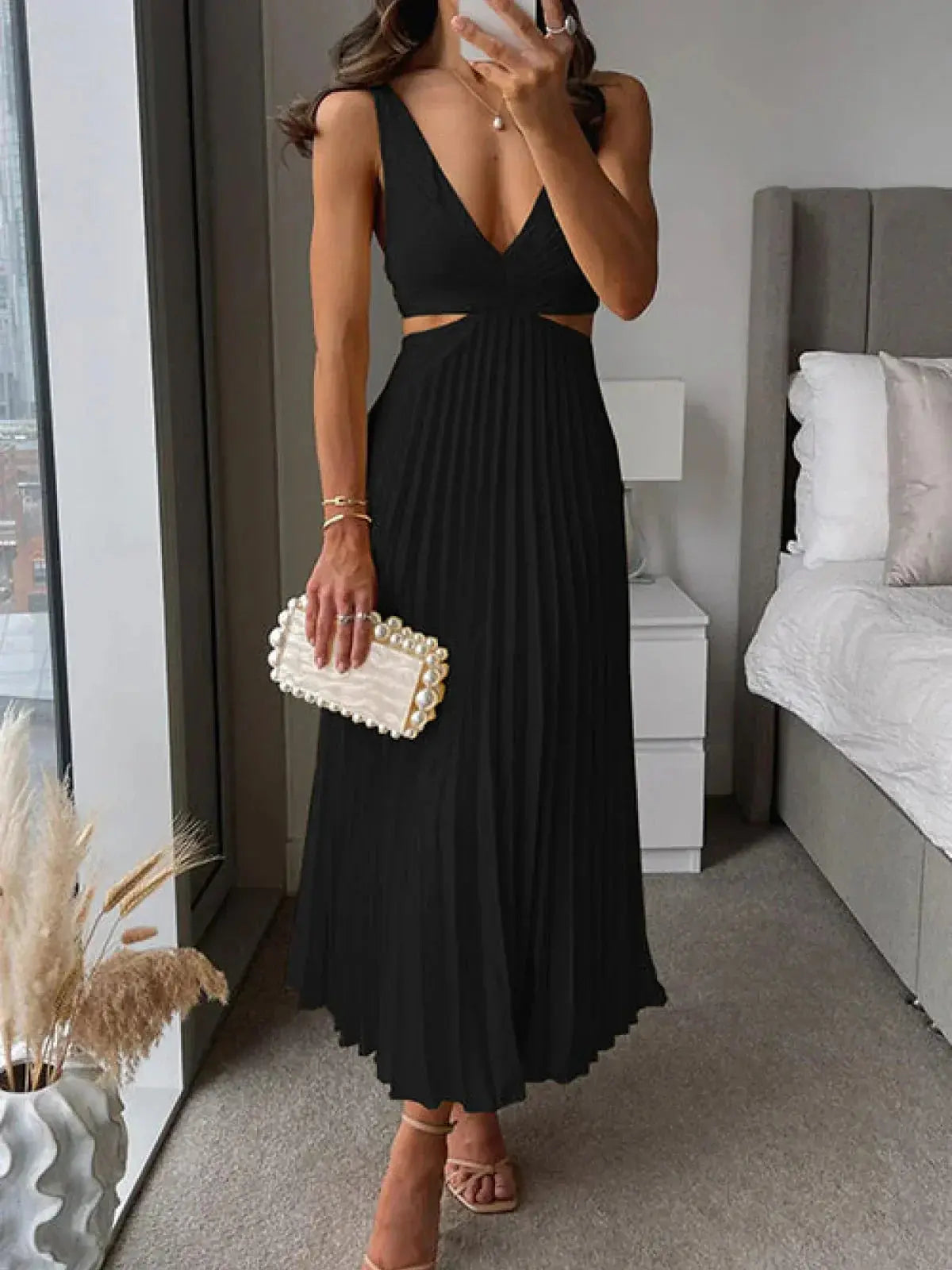 Black pleated cutout midi dress with deep V-neckline and side cutout
