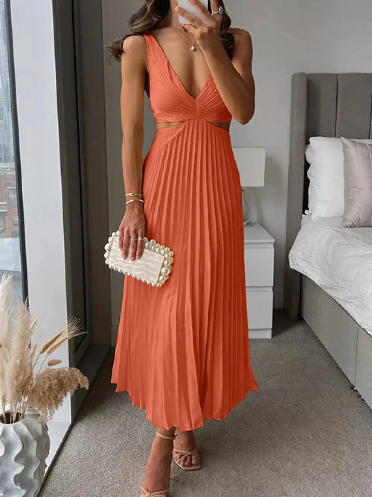 Coral pleated cutout midi dress with V-neckline and side cutout detail