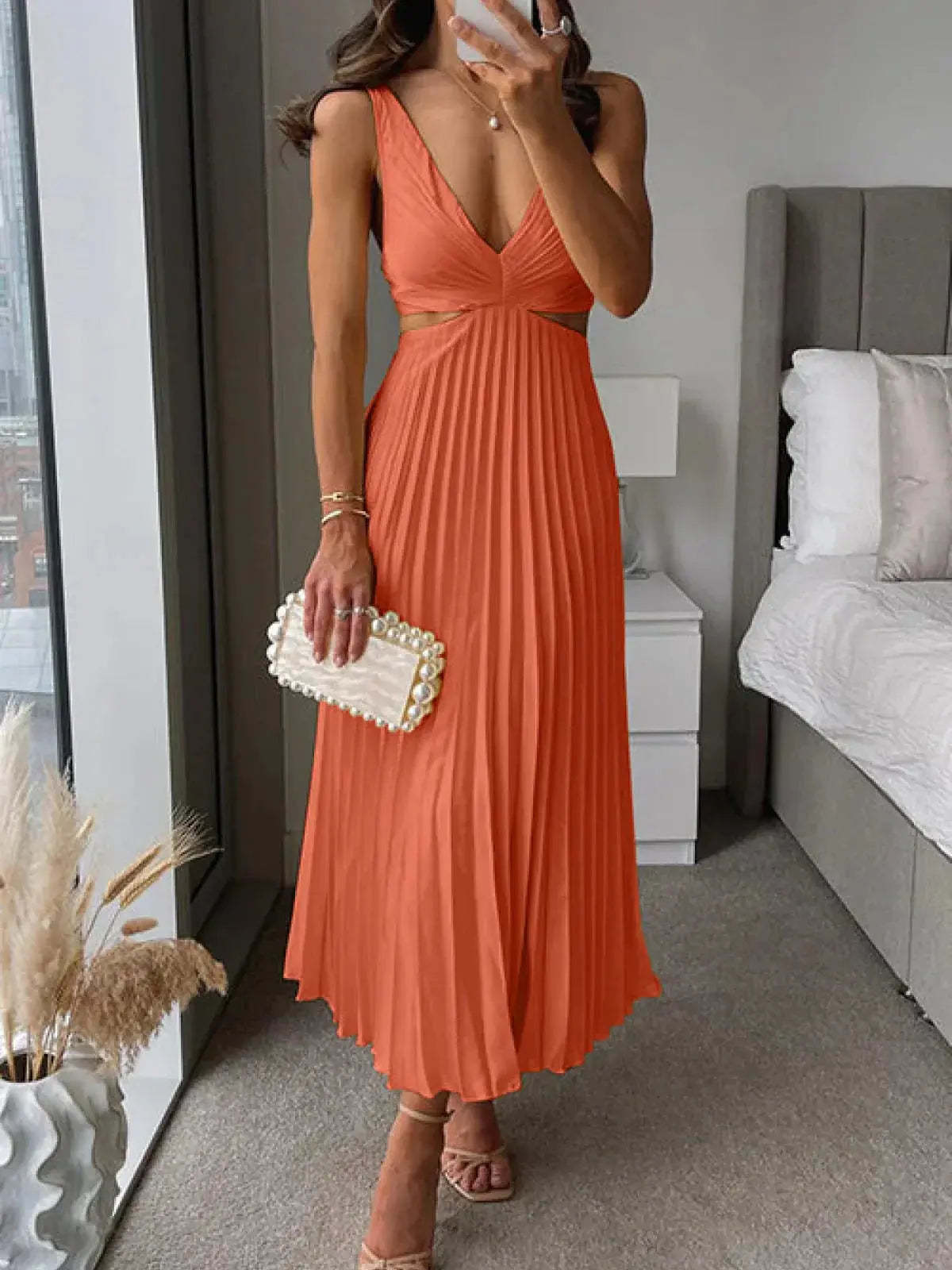 Coral pleated cutout midi dress with V-neckline and side cutout detail