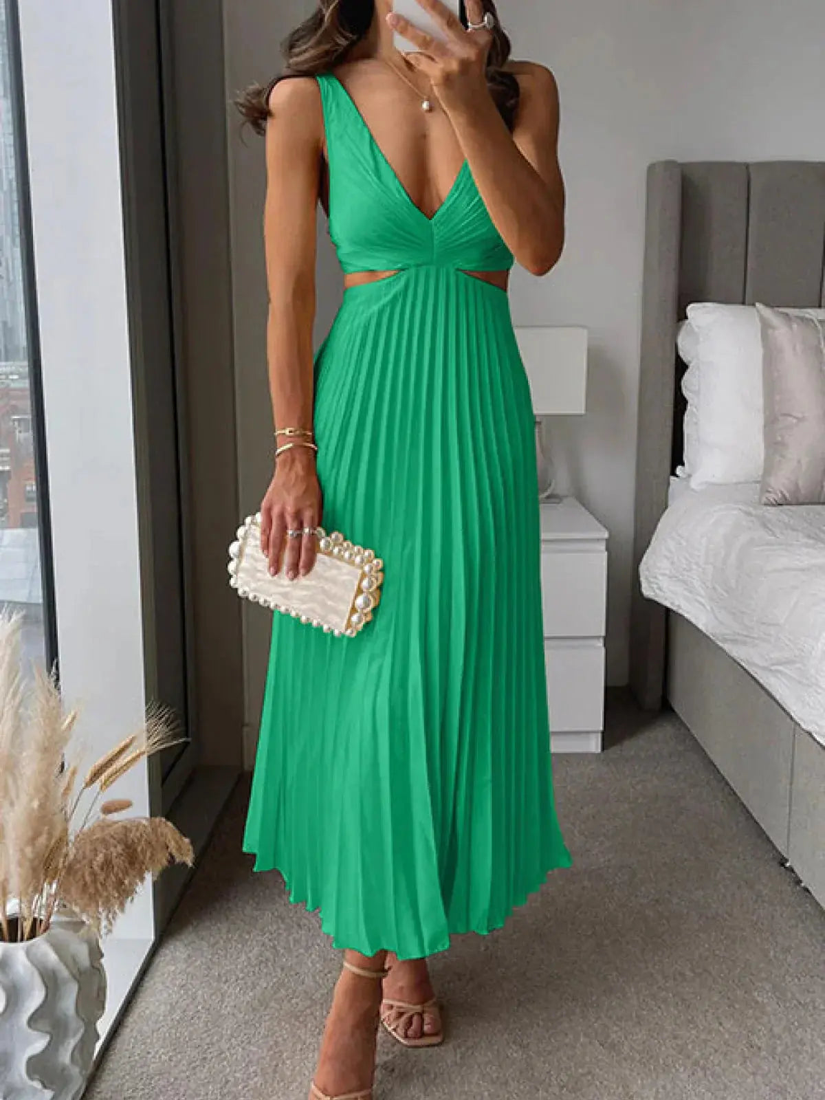 Emerald green pleated cutout midi dress with V-neck and waist cutout