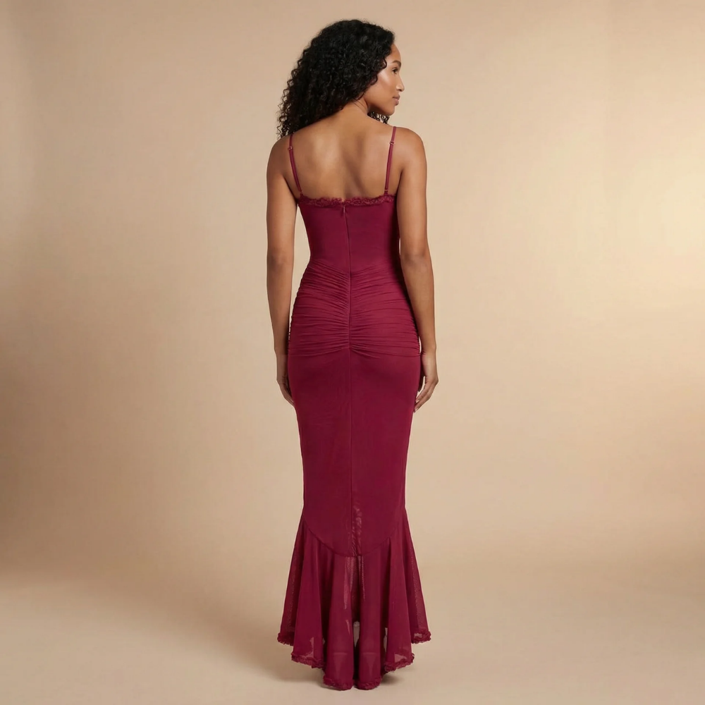 Back view of burgundy ruched maxi dress with thin straps and layered ruffled skirt