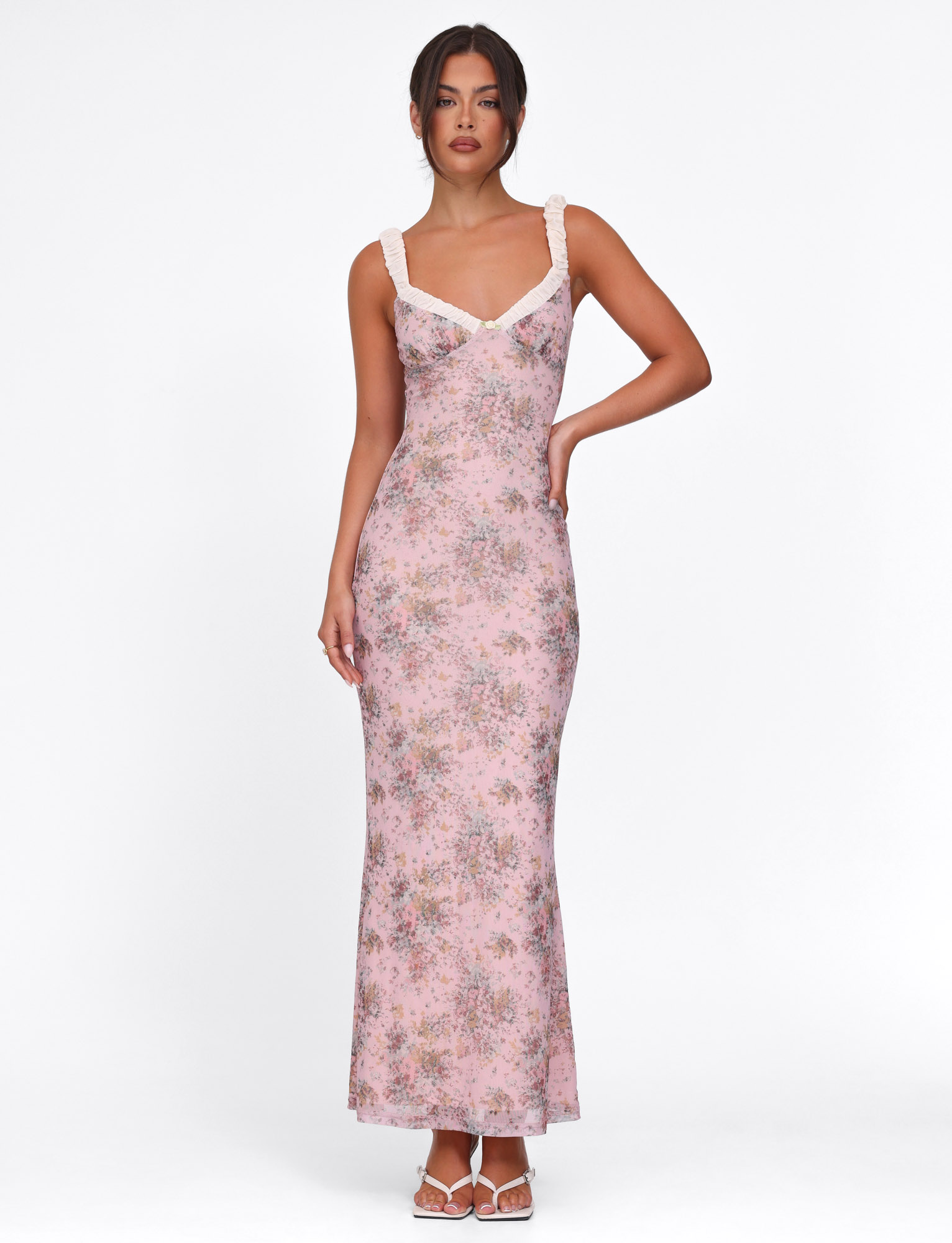 Full-length pink floral maxi dress with ruched bodice and white trim