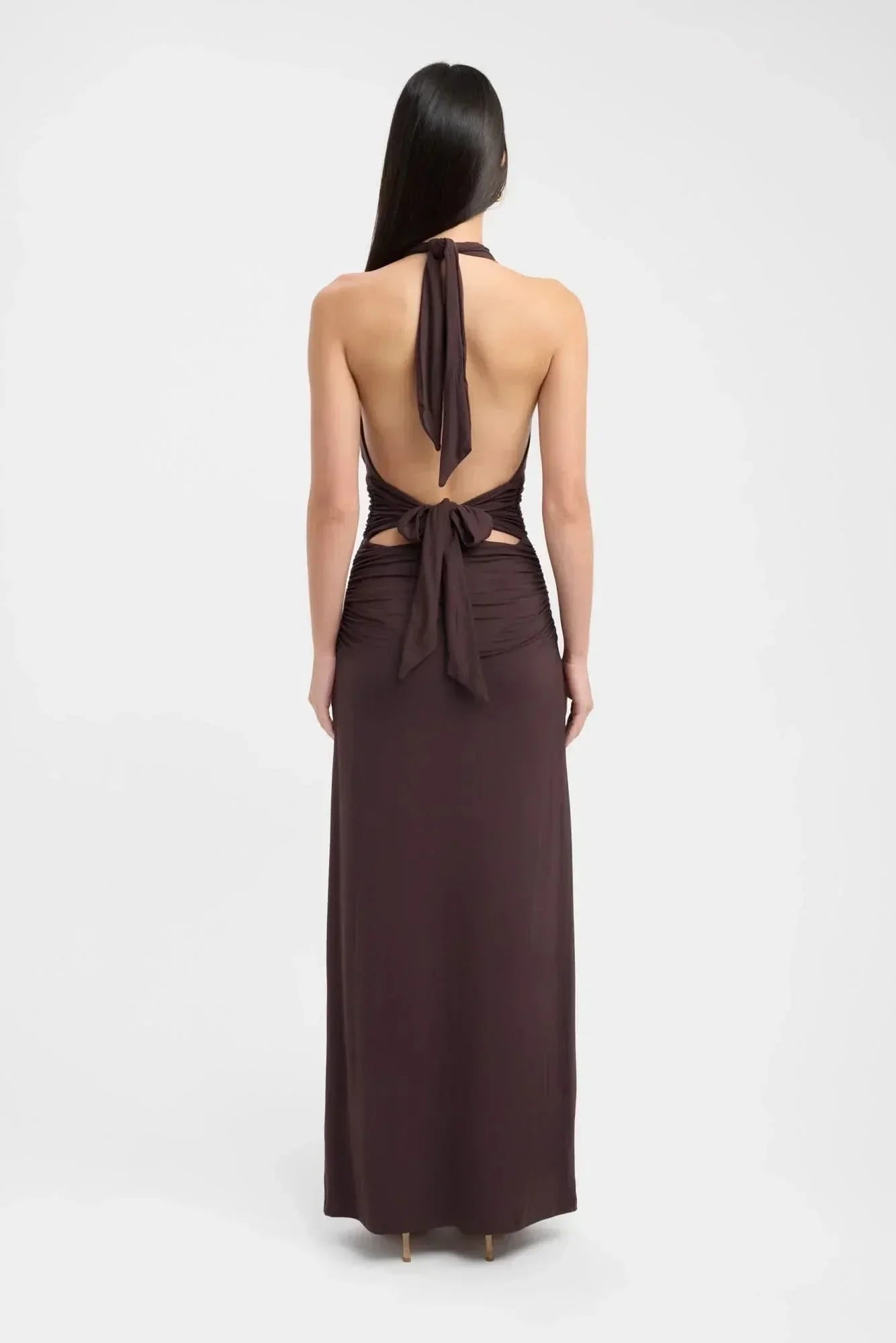 Back view of brown maxi dress with tied halter straps and open back