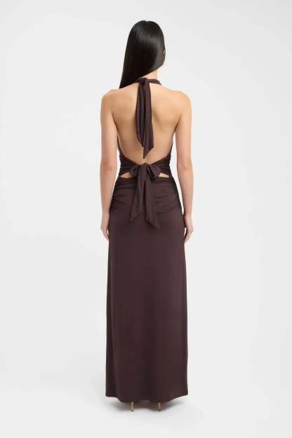 Back view of brown maxi dress with tied halter straps and open back