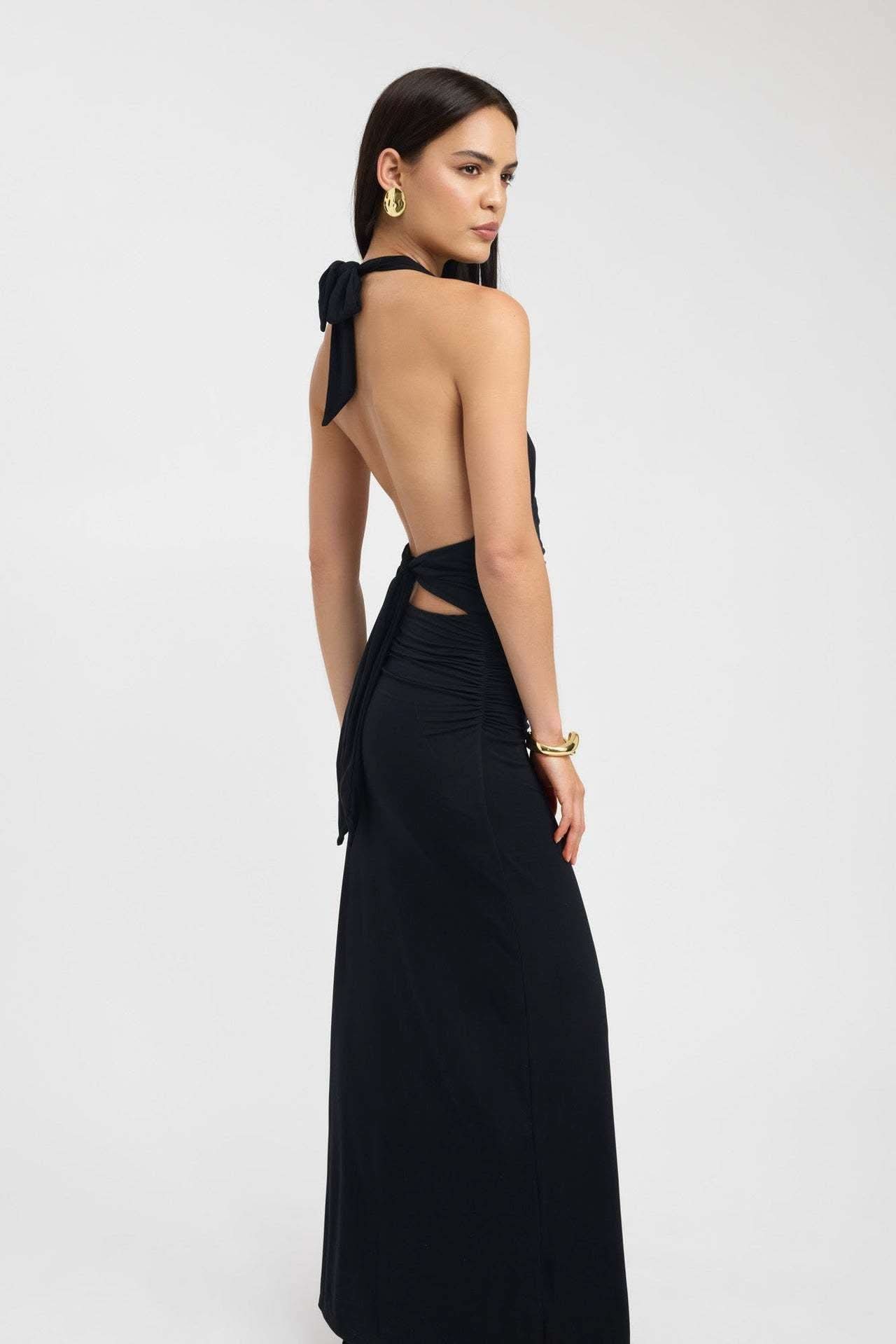 Side view of black maxi dress showing cutout ruched waist detail