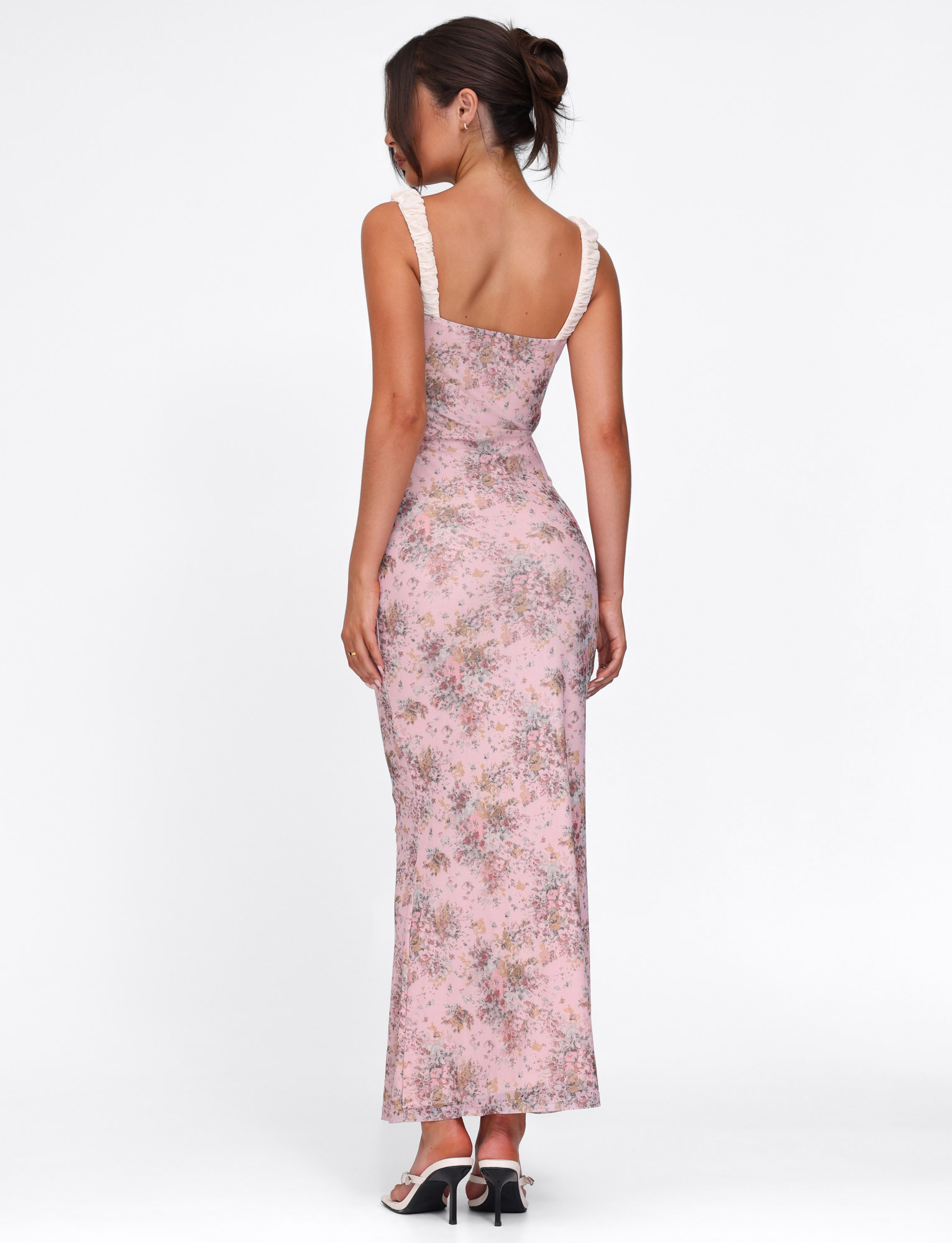 Back view of pink floral maxi dress showing open back and ruched detail