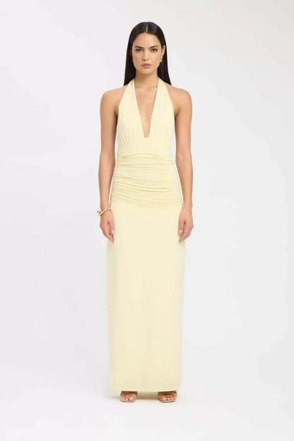 Pale yellow halter maxi dress with ruched waist and deep V-neck
