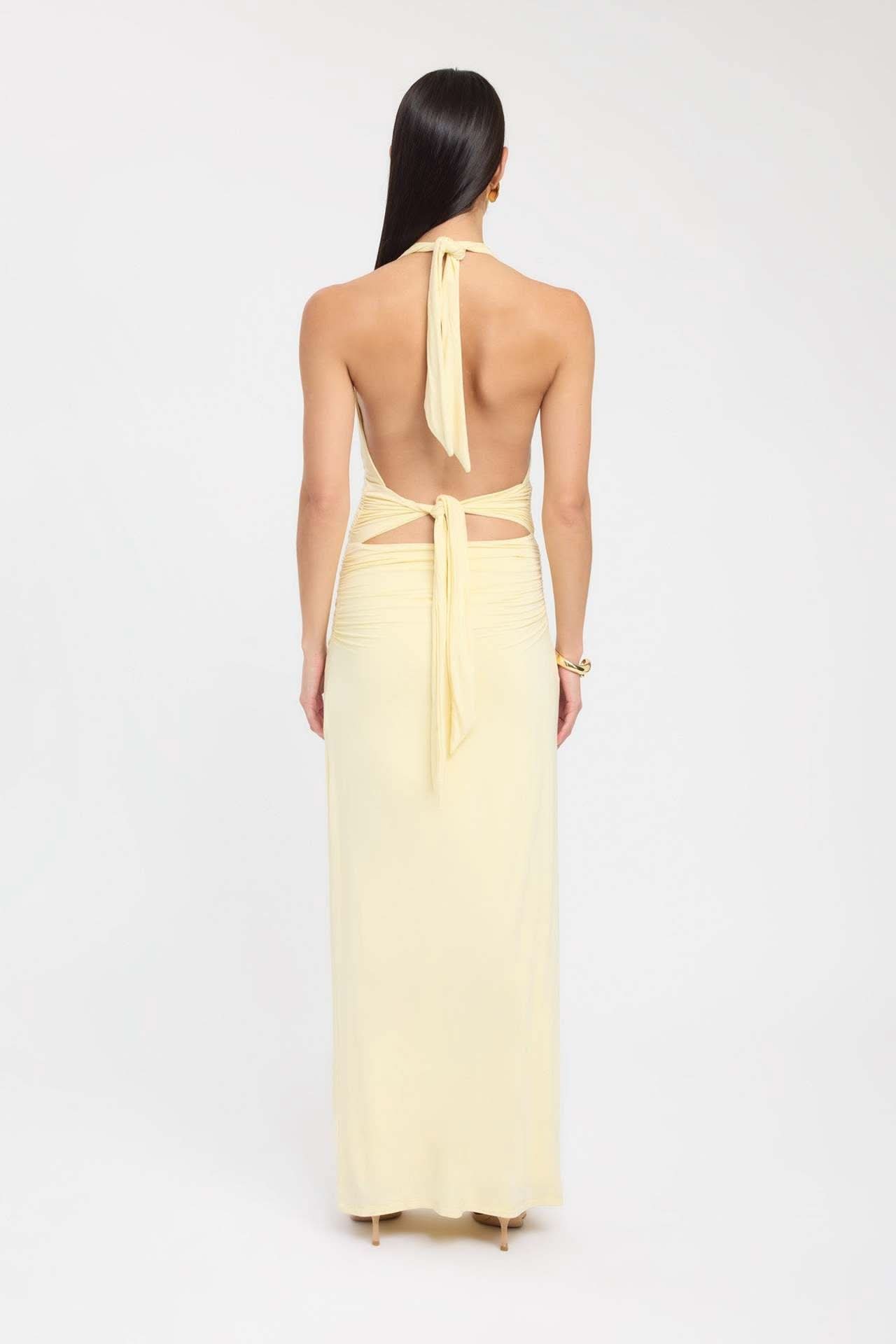 Back view of pale yellow maxi dress with halter tie and open back