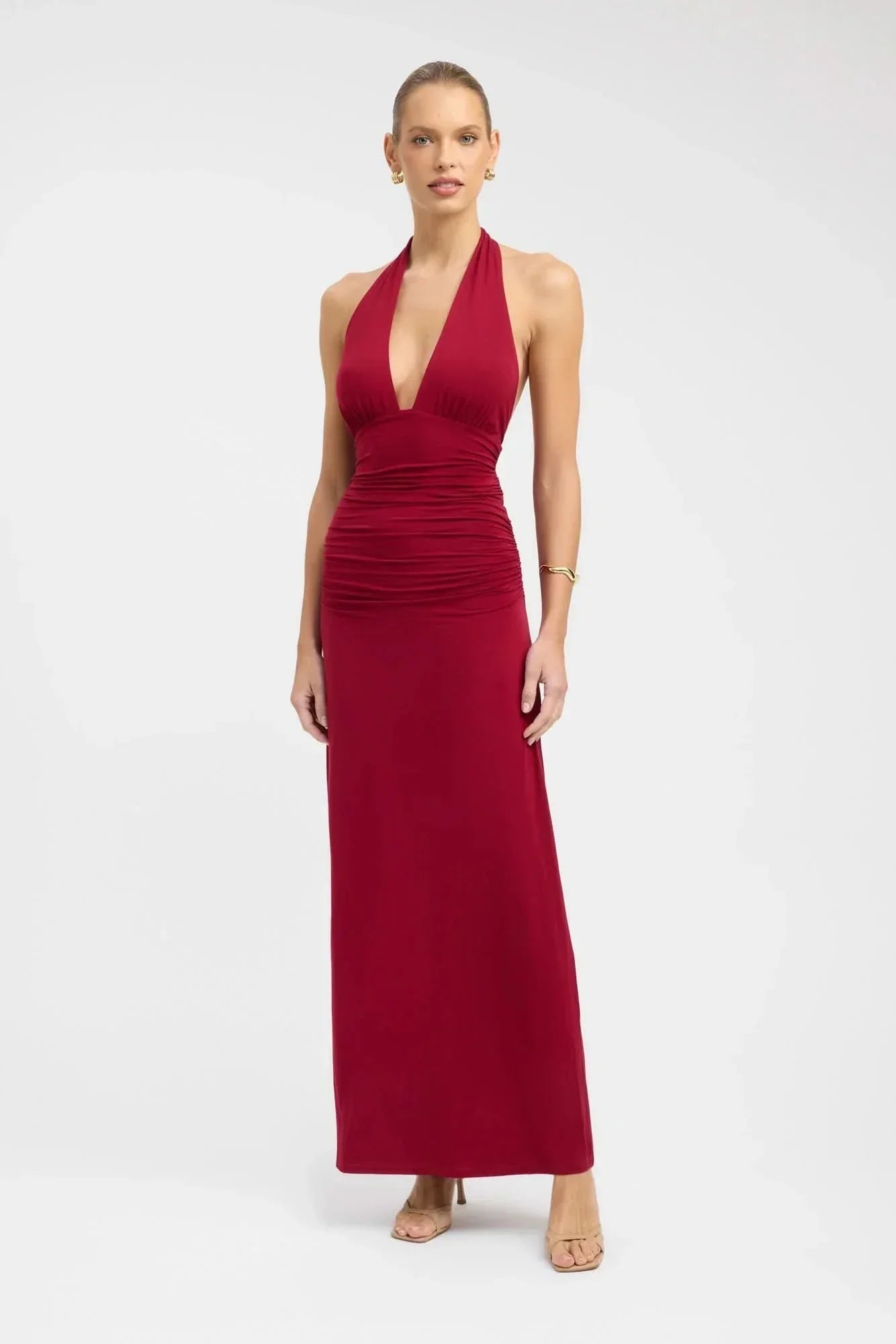 Red halter maxi dress with deep V-neckline and ruched waist detail