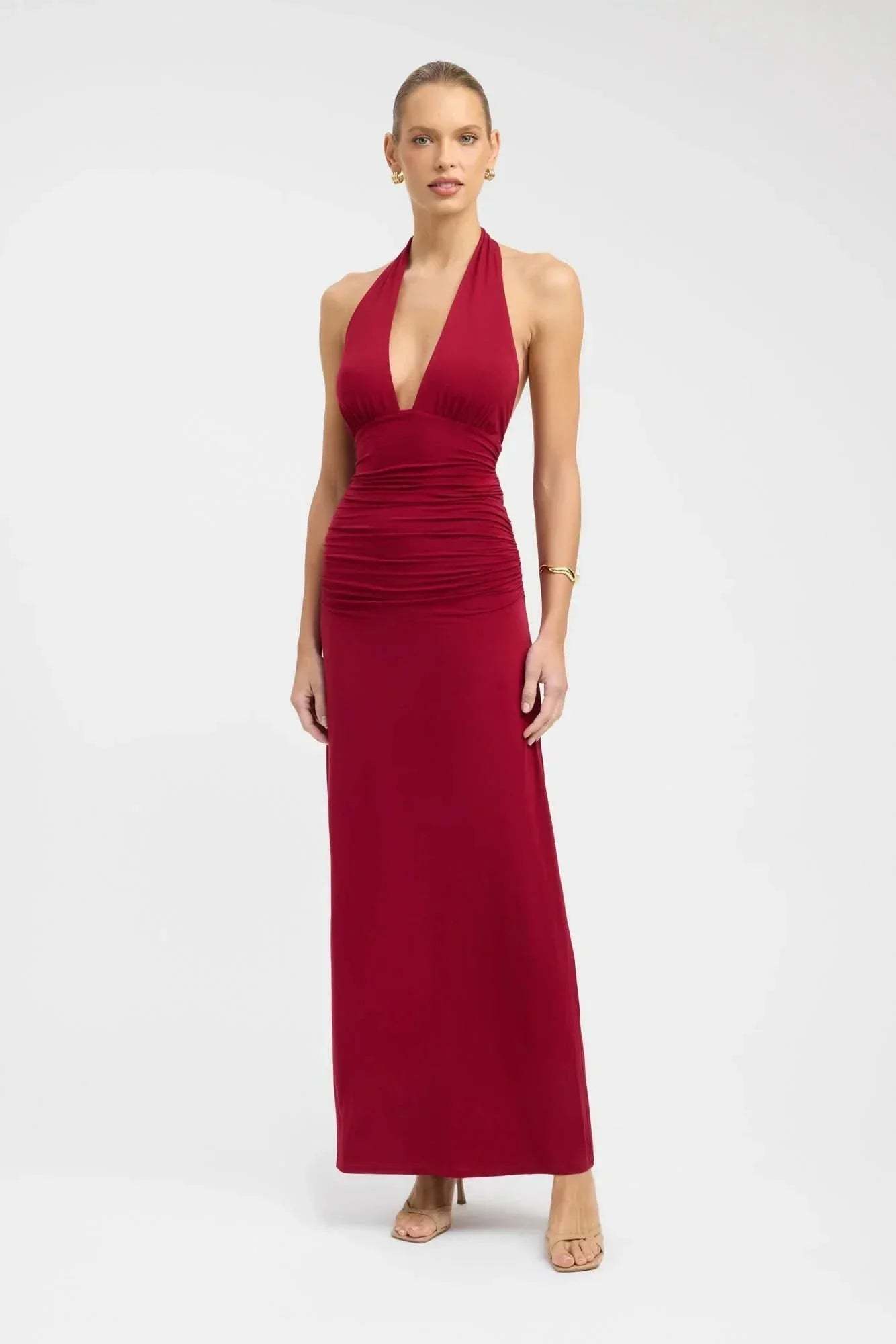 Red halter maxi dress with deep V-neckline and ruched waist detail