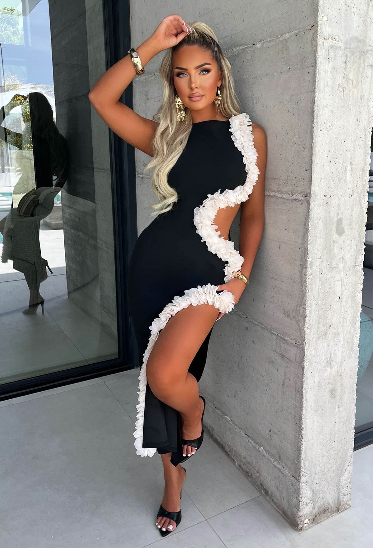 Black midi dress with white ruffled cutout trim down the side
