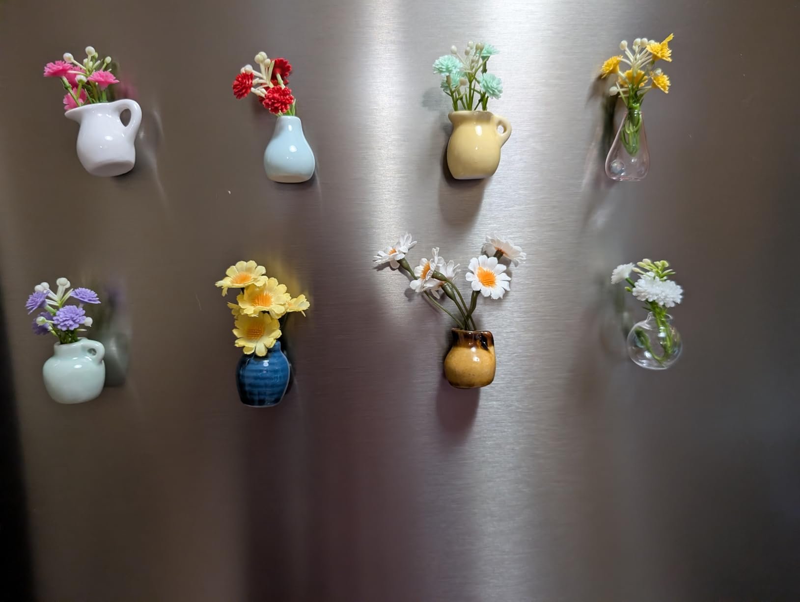 Pretty magnetic vases with flowers