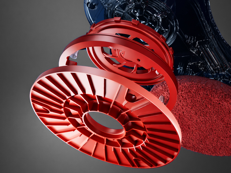 Primer plano de un ventilador o componente de ventilación de estilo industrial de color rojo brillante con aspas radiales curvas dispuestas en un patrón circular sobre un fondo oscuro.