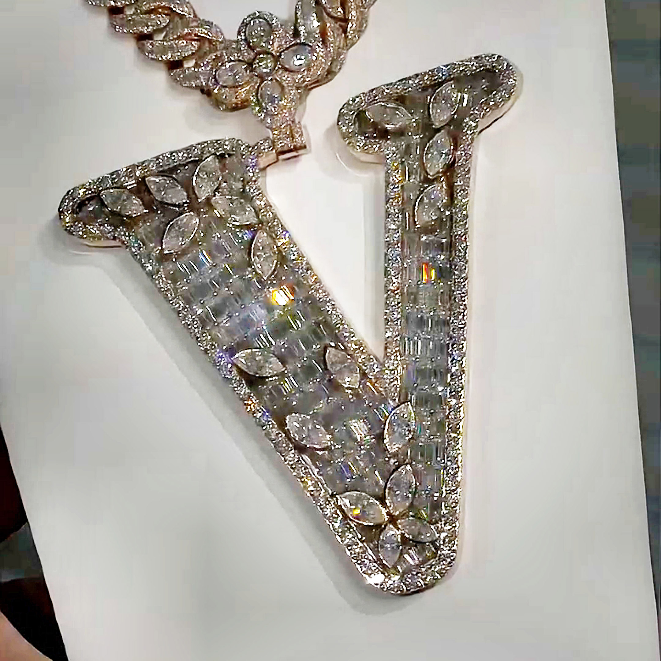 Close-up of marquise moissanite stones on Letter V pendant