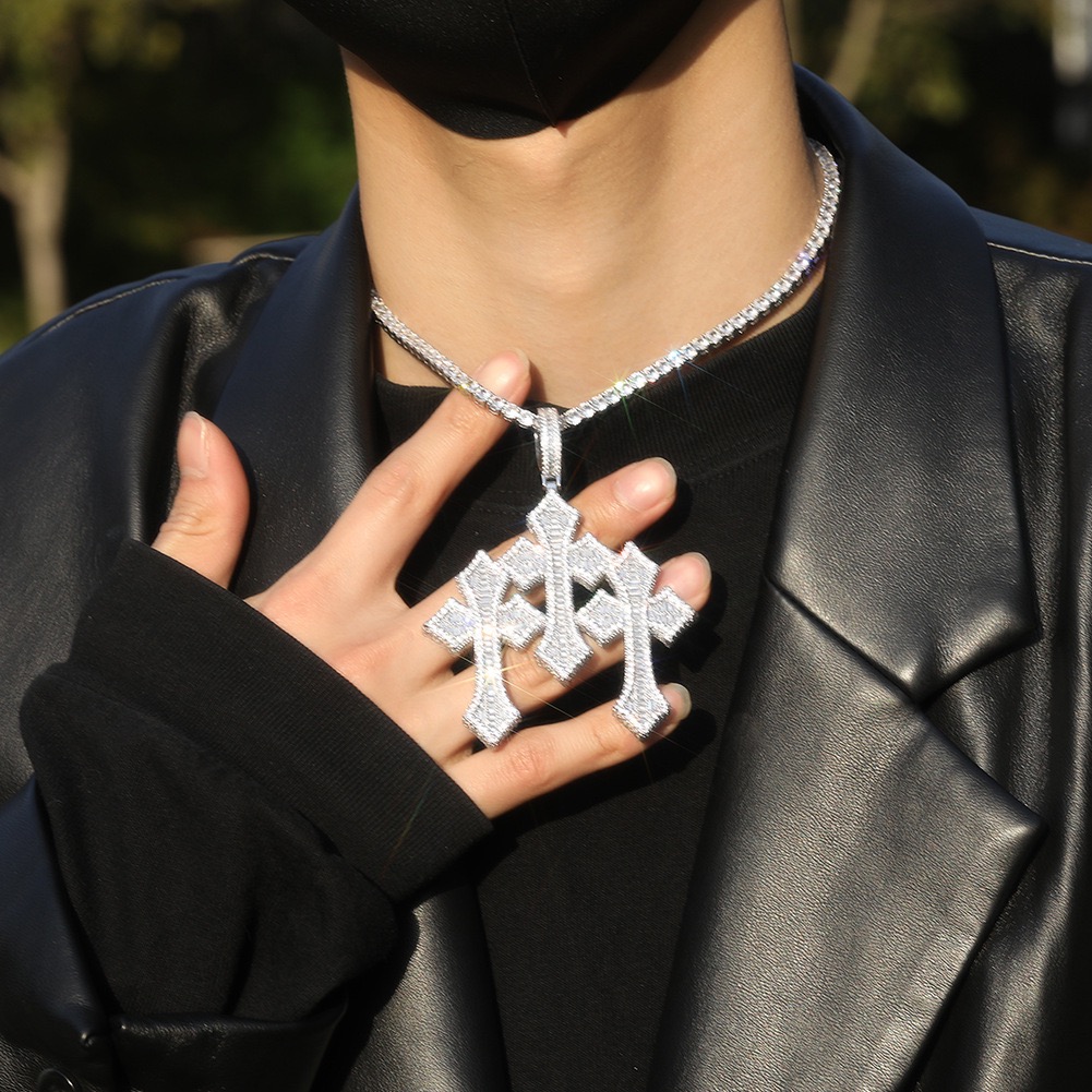 model wearing white gold baguette ornamental cross pendant luxury streetwear style