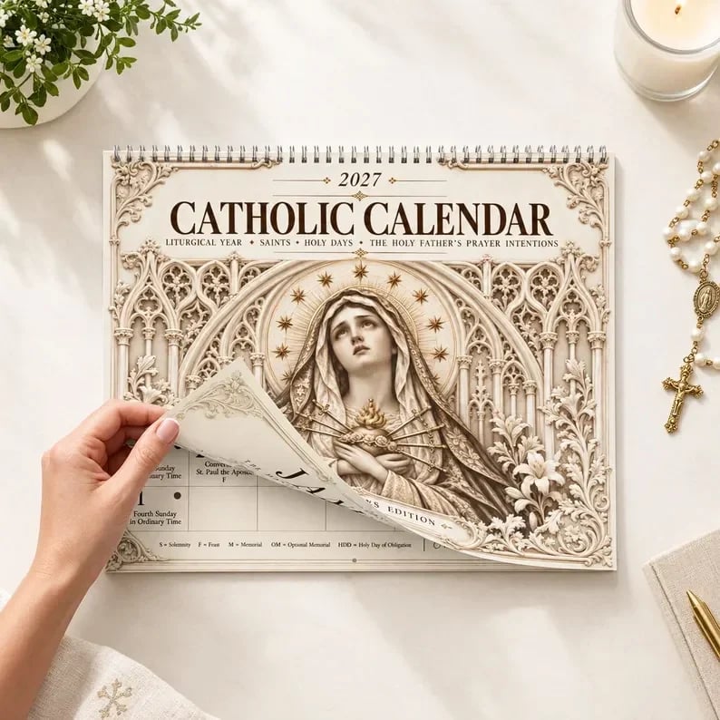 Hands turning the pages of the 2027 Catholic liturgical calendar