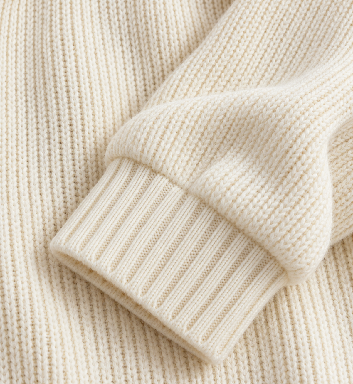 Close-up of the vertical rib knit meeting the sweater's ribbed cuff