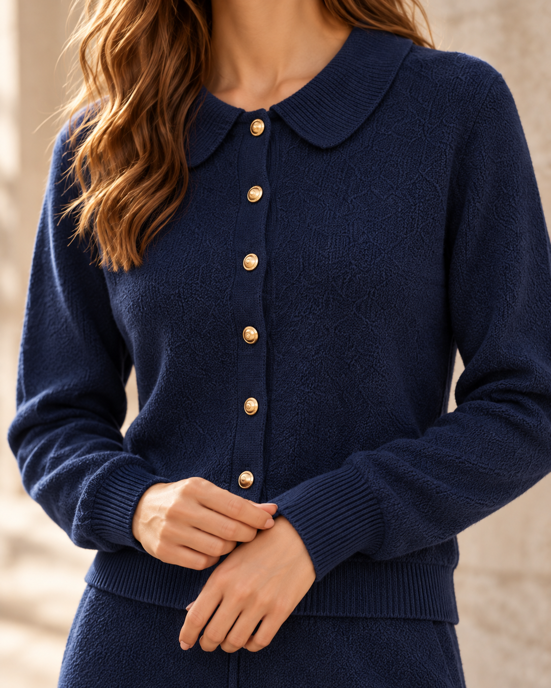 Close detail of the knit collar, buttons and sleeve texture