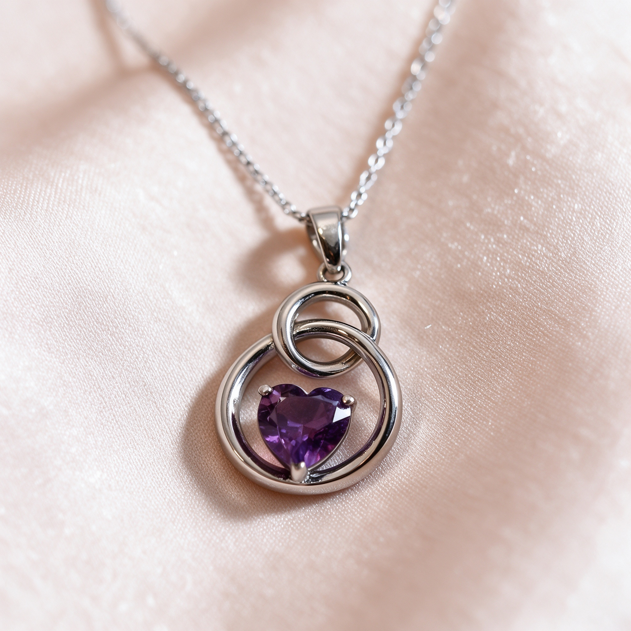 Openwork DetailClose up detail of purple heart necklace, openwork silver setting, fine jewelry detail shot