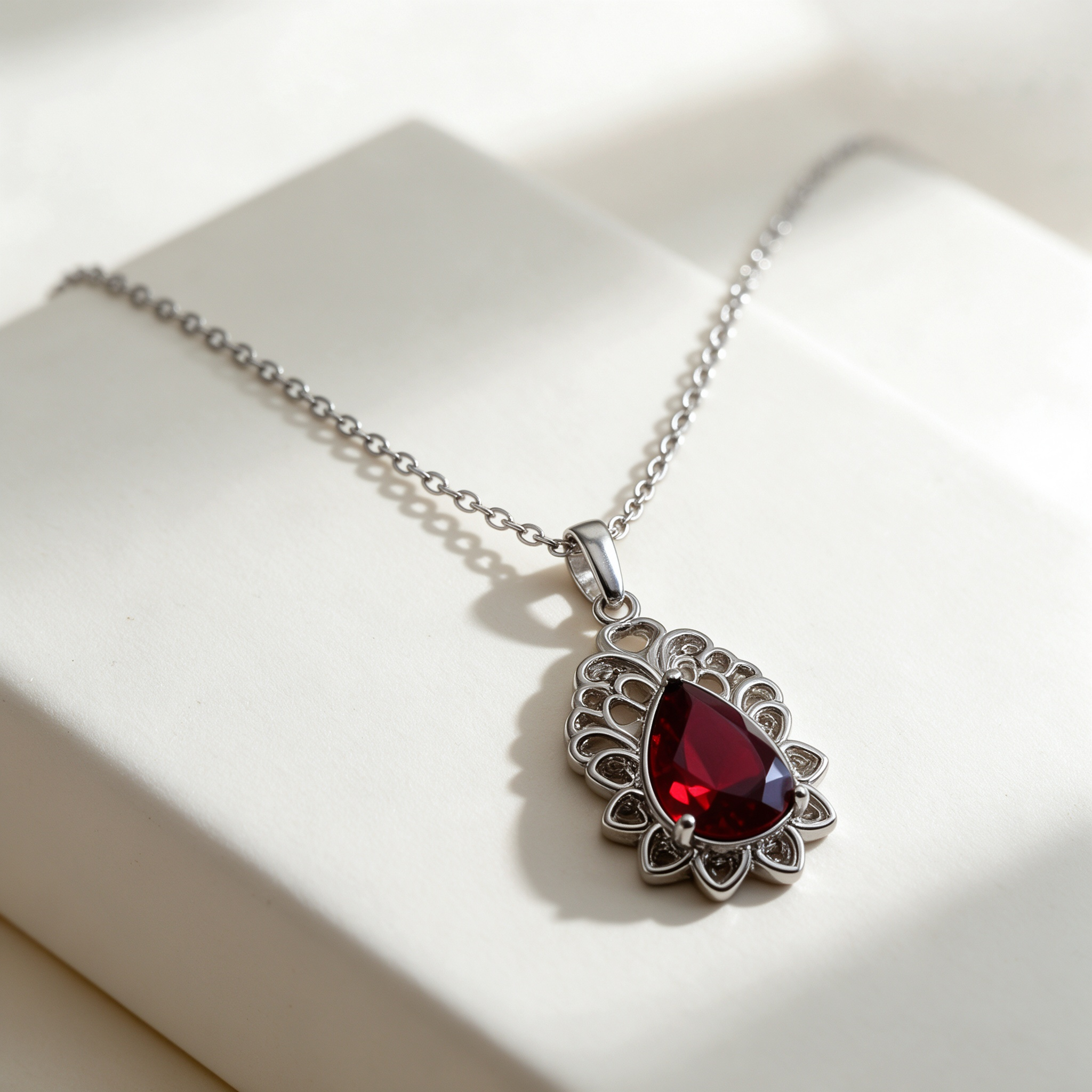 Red teardrop silver statement necklace, openwork silver pendant, luxury studio closeup, Bella Aurelia