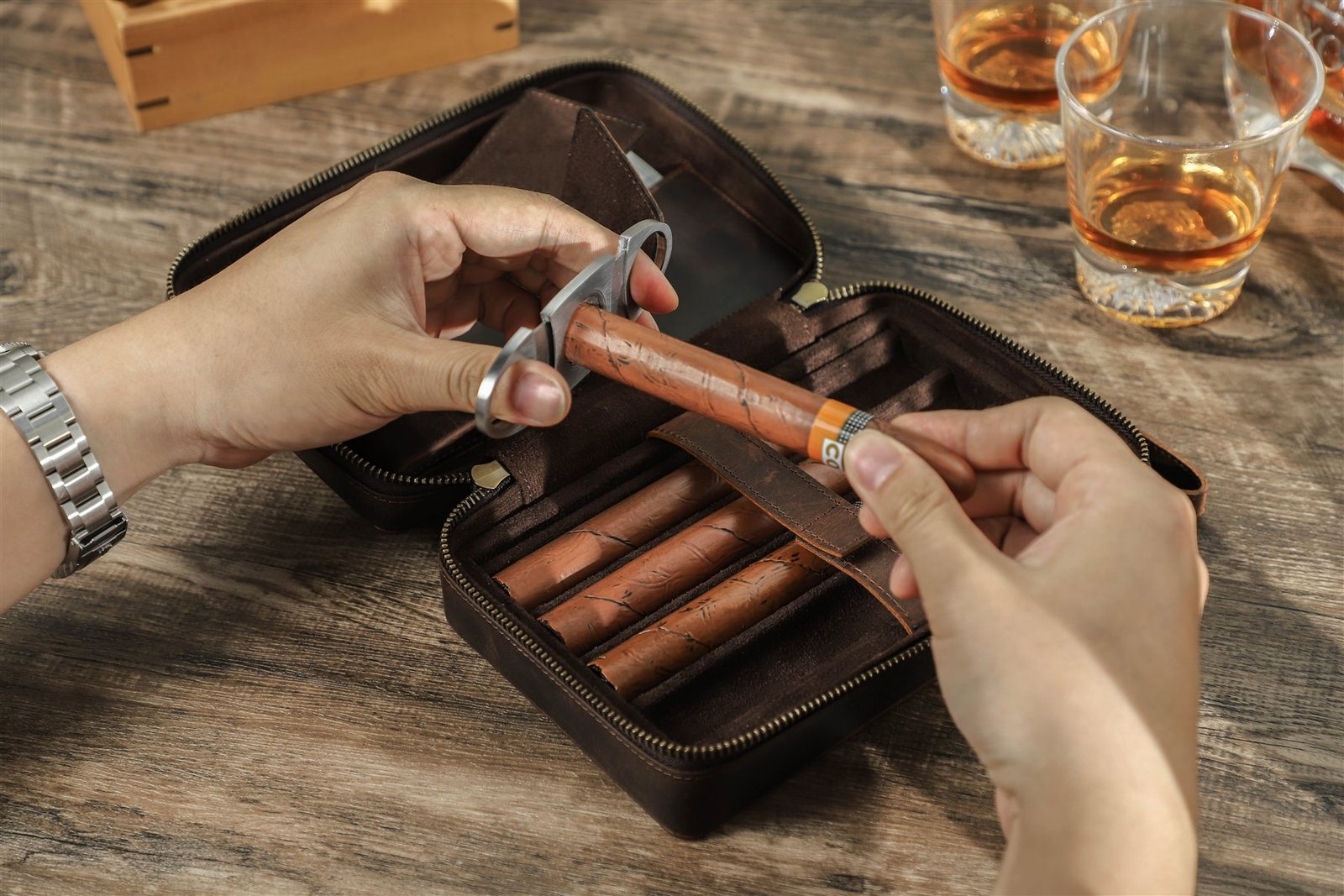 Hand removing a cigar from the leather retaining strap of the CF5010 case