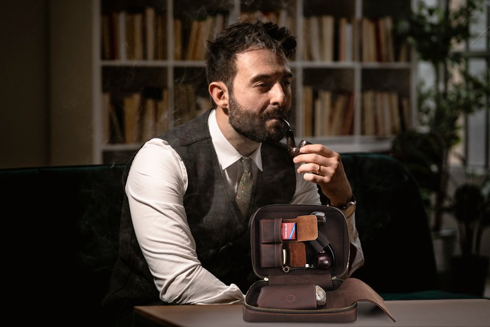 Man enjoying a pipe next to the open CF5016 leather pipe travel case