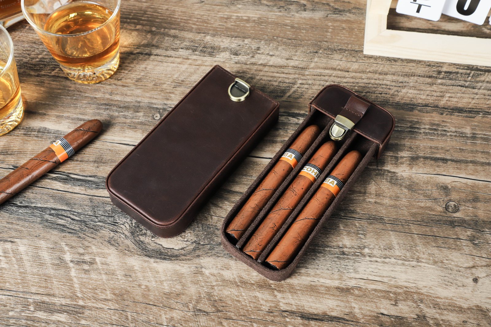 CF5018 leather case open on a wooden table with three cigars in the tray beside its sleeve