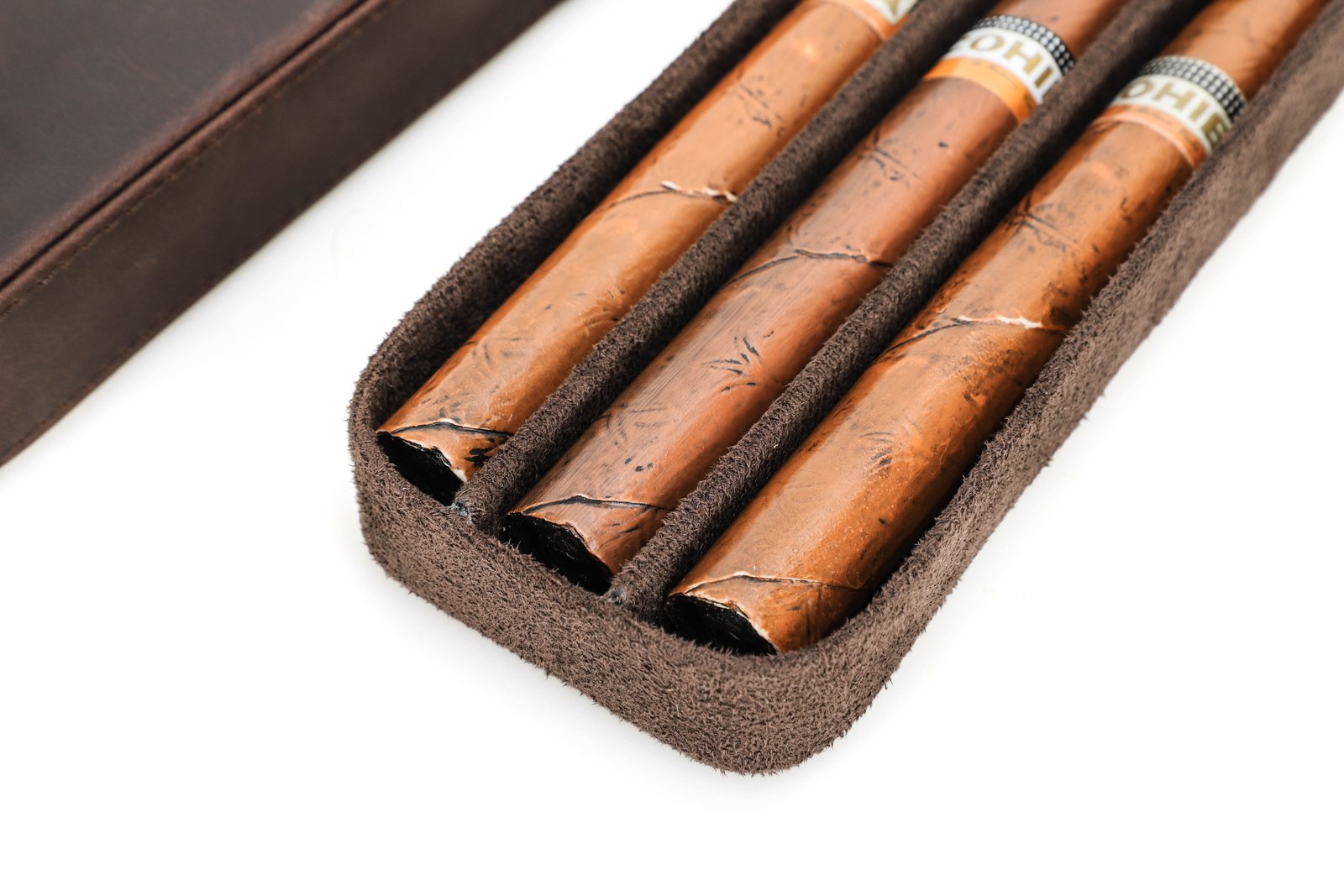 Close-up of three cigars resting in the CF5018 slots