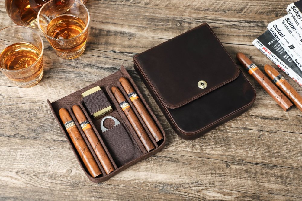 CF5021 open flat on a table with four cigars and accessories next to a glass of whisky