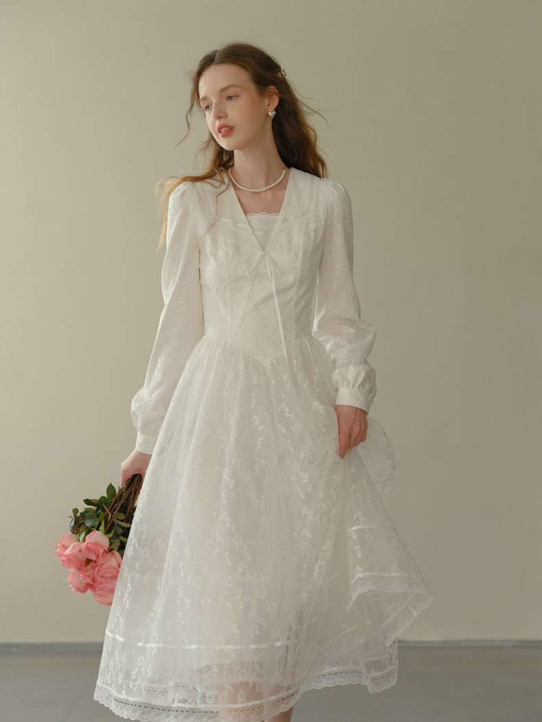 White lace midi dress with V-neck and long sleeves on model