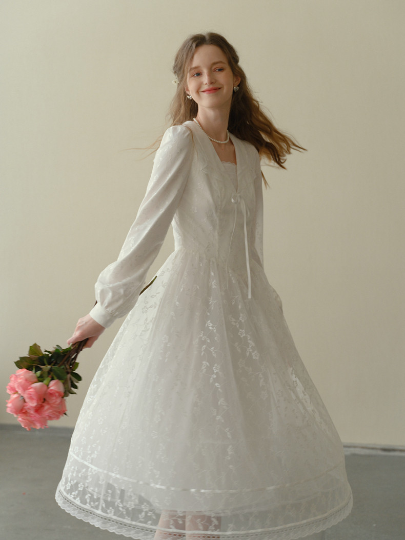 Close-up of white lace and embroidery detail
