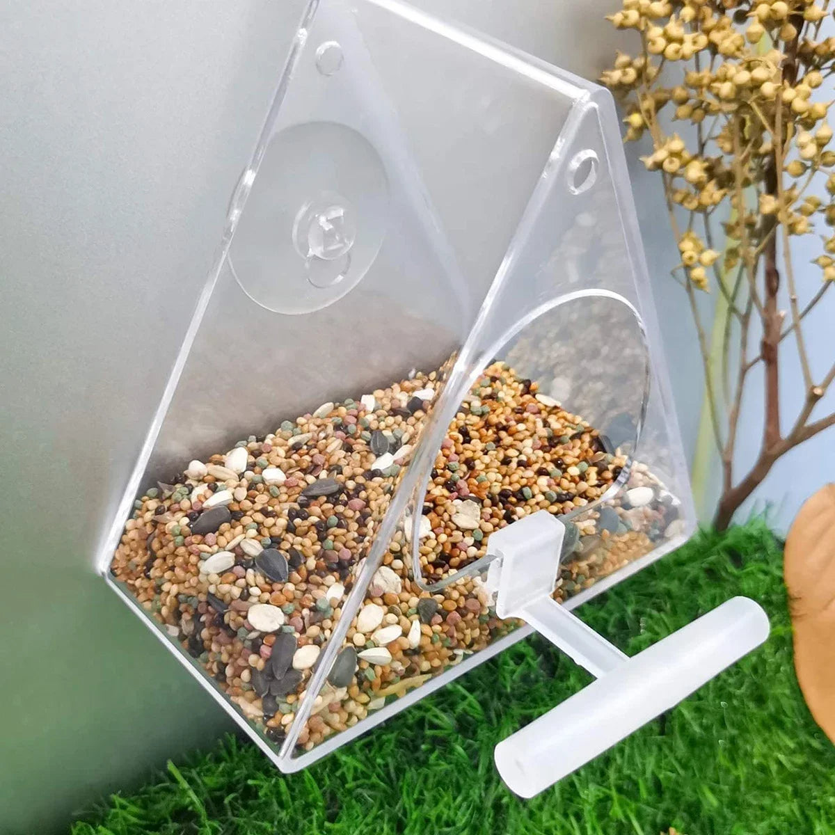 Acrylic bird feeder with triangular design and suction mount for windows or railings